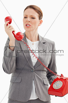 Angry businesswoman shouts at phone