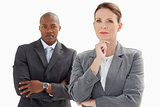 Businesswoman resting head on hand in front of businessman