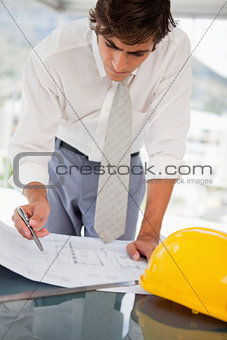 Businessman with blueprints of a building