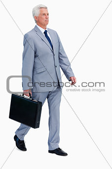 Businessman with a suitcase walking 