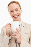 Portrait of a woman in a suit holding a mug