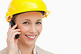 Portrait of a woman wearing safety helmet on the phone