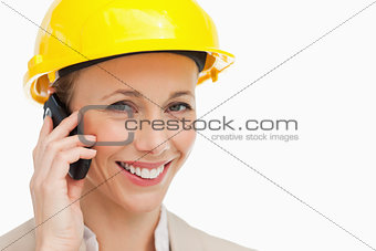 Portrait of a woman wearing safety helmet on the phone
