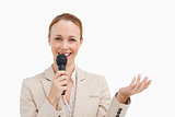 Portrait of a businesswoman speaking with a microphone 