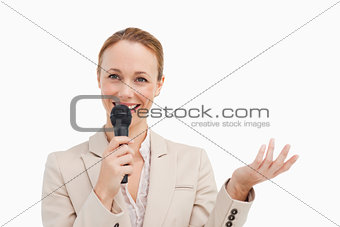 Pretty woman in a suit speaking with a microphone 