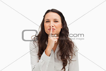 Portrait of a brunette with a finger on the lips