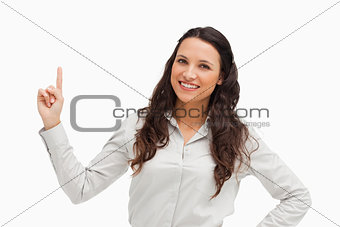 Portrait of a brunette pointing up