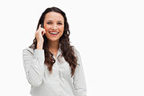 Close-up of a brunette grimacing while phoning