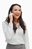 Close-up of a brunette smiling while phoning