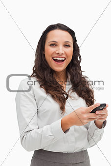 Portrait of a happy brunette looking her text message