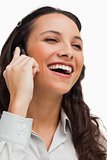 Close-up of a brunette beaming while calling