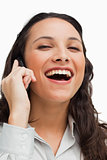 Portrait of a brunette laughing while calling