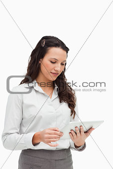 Brunette standing while using a touchpad