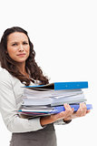 Brunette carrying a lot of files 