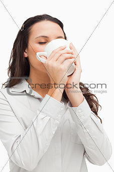 Brunette drinking a hot coffee