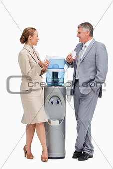 Business people talking next to the water dispenser 