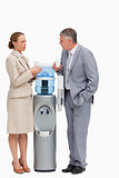 People in suit talking next to the water dispenser 