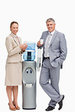 Portrait of smiling business people next to the water dispenser 