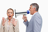 Businessman screaming after his colleague with a megaphone 