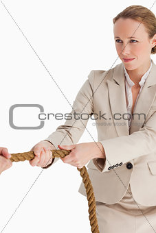 Businesswoman pulling a rope
