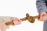 Business people tightening a knot 