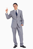 Smiling man in suit pointing up