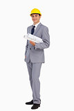 Man in a suit with safety helmet and plans 