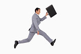 Businessman running with a suitcase