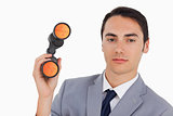 Close-up of a handsome businessman with binoculars 