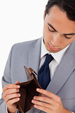 Man in a suit showing his empty wallet 