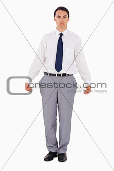 Upset man showing his empty pockets