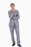 Thoughtful businessman with folded arms