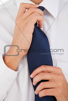 Man tightening his tie 