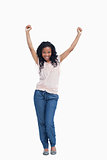 A young happy woman stands with her hands in the air
