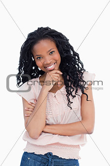 A smiling young woman is looking at the camera