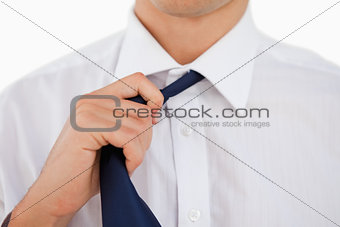 Close-up of a man undoing his tie 