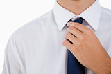 Close-up of a man doing his tie 