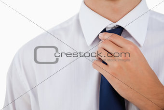 Close-up of a man doing his tie 