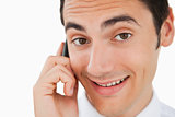 Close-up of a happy man calling with his cellphone