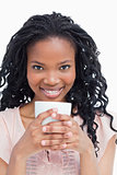 A woman is holding cup of coffee with both hands