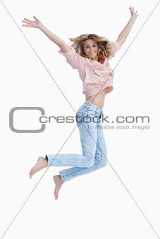 Woman jumping up with her arms raised