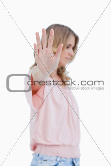 Side view of a woman with her hand held up to the camera