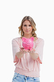 Woman holding a piggy bank in the palms of her hands
