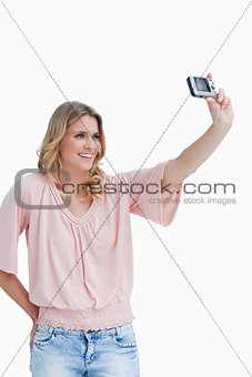 A woman talking a photo of herself with her camera