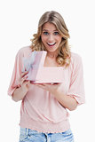 Young woman showing her surprise with a present