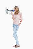 Young woman shouting with a megaphone