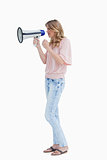 Serious young woman holding a megaphone