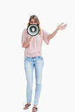 Young woman standing upright while using a megaphone