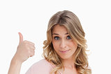 Young blonde woman putting her thumbs up