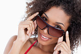 Smiling woman looking aver her sunglasses